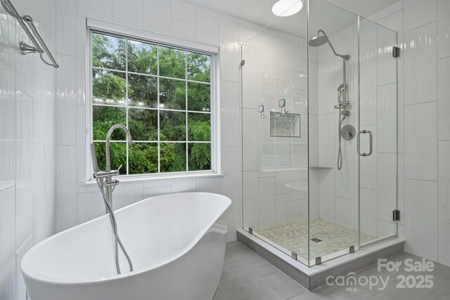 6723 Joliette Ln, Charlotte, NC 28277 - bathroom featuring a shower stall, tile patterned flooring, and a freestanding tub