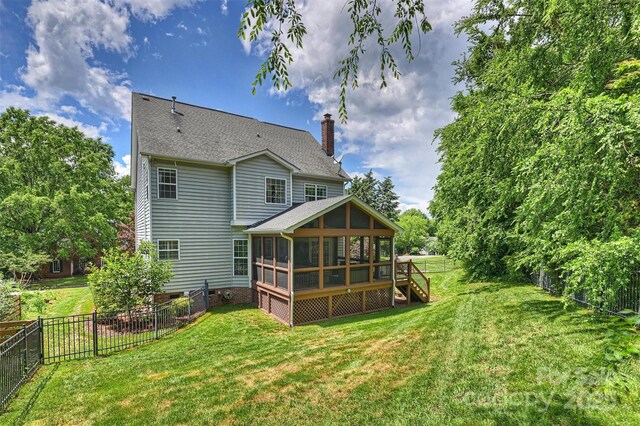 6723 Joliette Ln, Charlotte, NC 28277 - rear view of property featuring a sunroom, a chimney, and roof with shingles