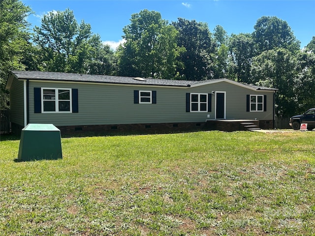 manufactured / mobile home featuring crawl space and a front lawn