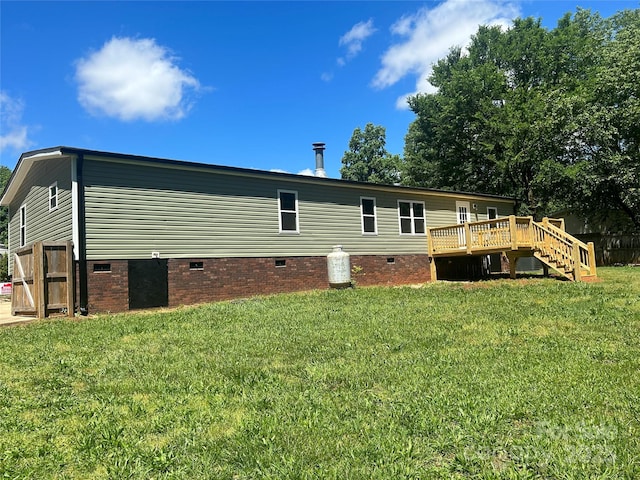 back of property featuring a yard and a deck