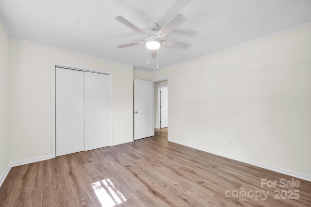 612 Summerow Rd Lot 22, Stanley, NC 28164 - unfurnished bedroom featuring baseboards, ornamental molding, a closet, and wood finished floors