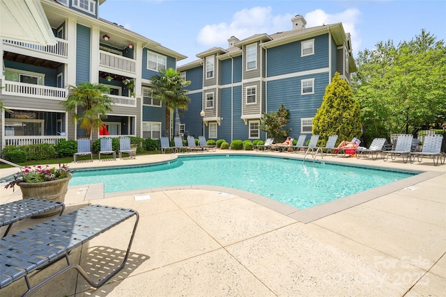 community pool with a patio area