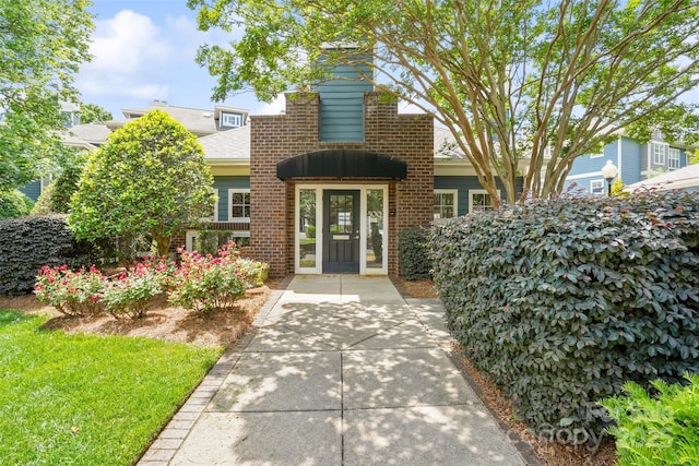 property entrance with brick siding