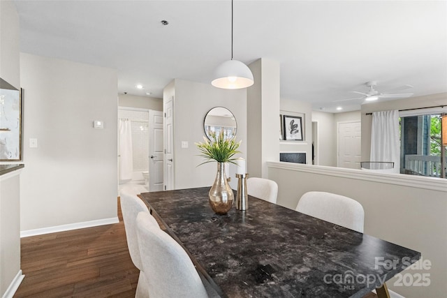 dining area with dark wood-type flooring, baseboards, a ceiling fan, and recessed lighting