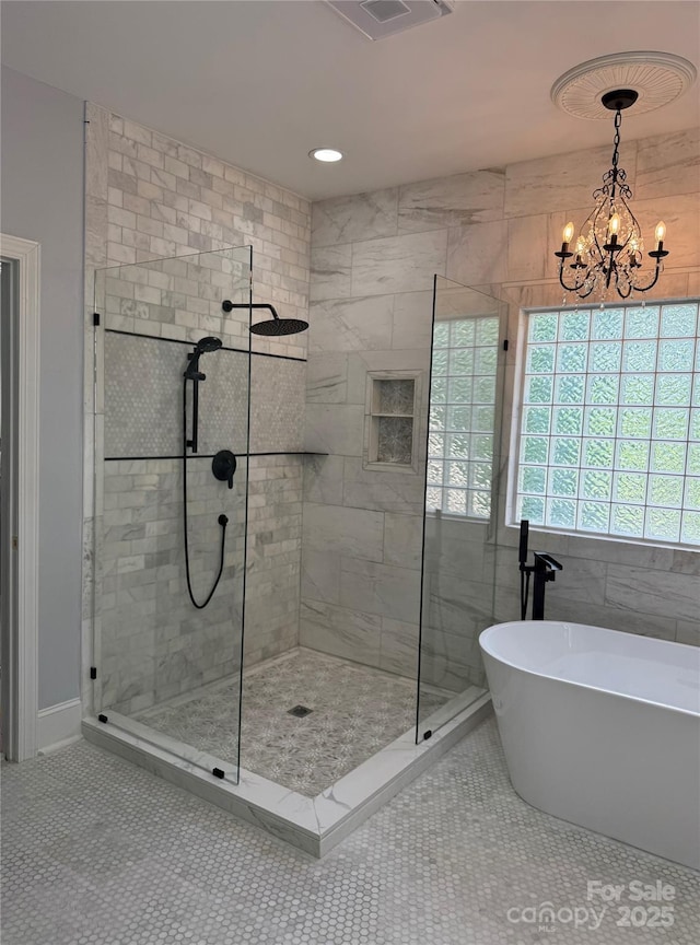 19409 Laurel Glen Ave, Cornelius, NC 28031 - full bathroom with a chandelier, a freestanding bath, a shower stall, and visible vents
