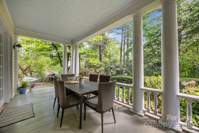 100 Poplar Spring Trl, Hendersonville, NC 28739 - porch with outdoor dining space and view of wooded area