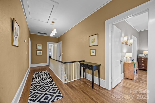 100 Poplar Spring Trl, Hendersonville, NC 28739 - hall with attic access, wood finished floors, crown molding, and an upstairs landing