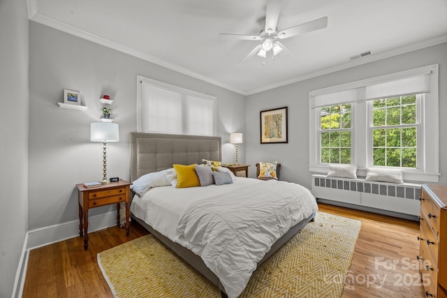 100 Poplar Spring Trl, Hendersonville, NC 28739 - bedroom featuring radiator, crown molding, wood finished floors, and a ceiling fan