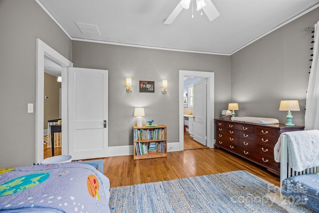 100 Poplar Spring Trl, Hendersonville, NC 28739 - bedroom featuring ornamental molding, wood finished floors, a ceiling fan, and connected bathroom