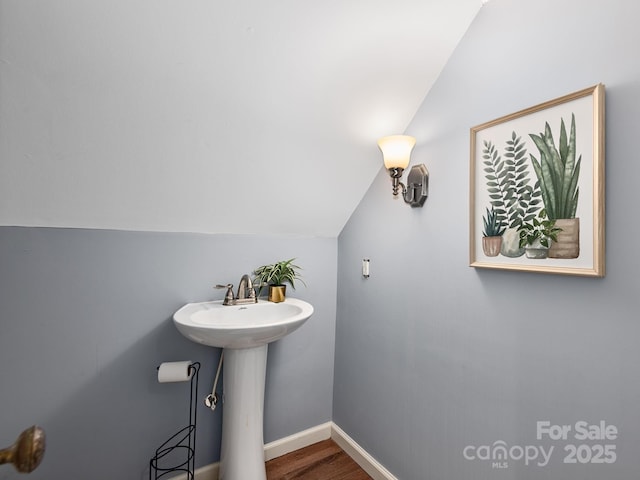 21 Clairmont Ave, Asheville, NC 28804 - bathroom featuring vaulted ceiling, wood finished floors, baseboards, and a sink