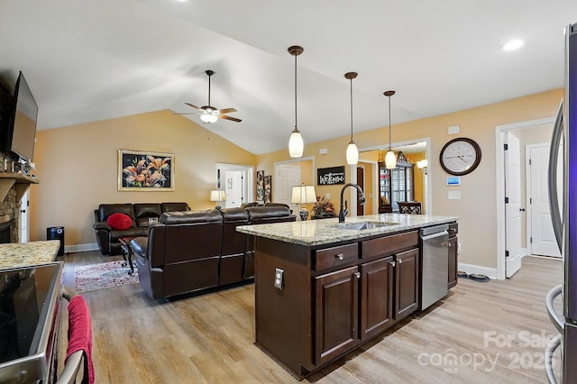 kitchen featuring a sink, light wood-style floors, ceiling fan, and stainless steel dishwasher
