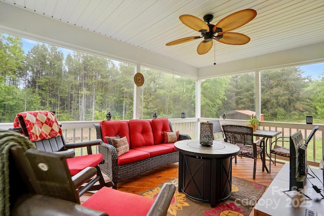 sunroom / solarium with a ceiling fan and an outdoor hangout area