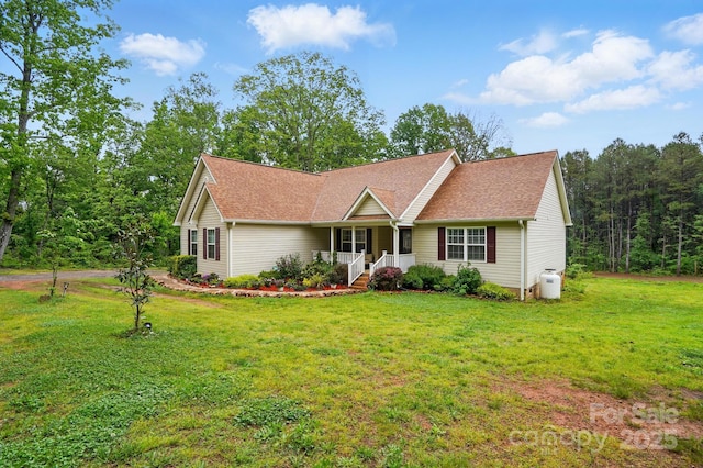 ranch-style home featuring a shingled roof, a front lawn, and covered porch