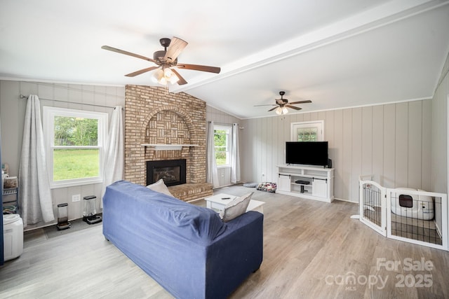 1211 Mirror Park Dr, Salisbury, NC 28146 - living area featuring lofted ceiling with beams, ceiling fan, light wood-type flooring, and a brick fireplace