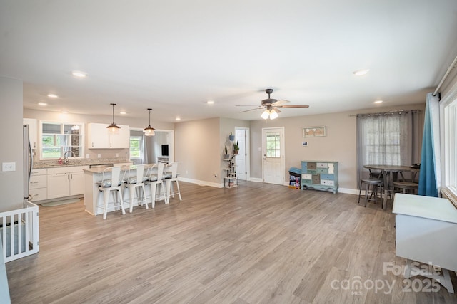 1211 Mirror Park Dr, Salisbury, NC 28146 - living room with light wood finished floors, recessed lighting, ceiling fan, and baseboards