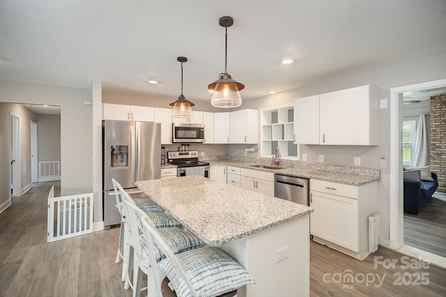 1211 Mirror Park Dr, Salisbury, NC 28146 - kitchen featuring a sink, a center island, visible vents, light wood-style flooring, and appliances with stainless steel finishes