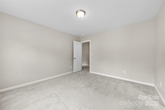 carpeted spare room with baseboards