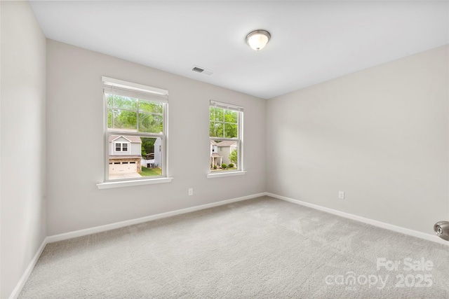 unfurnished room with carpet flooring and baseboards