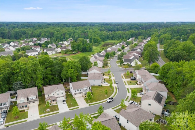 aerial view of residential area featuring a forest