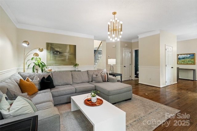 living room featuring crown molding, stairway, wood finished floors, and a chandelier