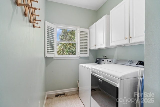 washroom with tile patterned floors, cabinet space, washing machine and clothes dryer, baseboards, and visible vents