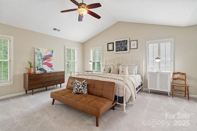 bedroom with visible vents, vaulted ceiling, light colored carpet, and baseboards