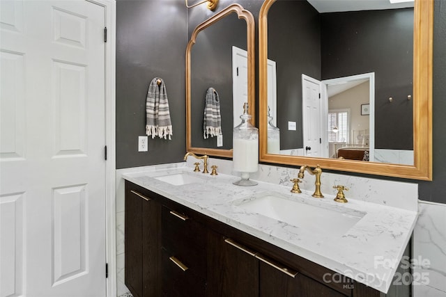 bathroom featuring double vanity and a sink