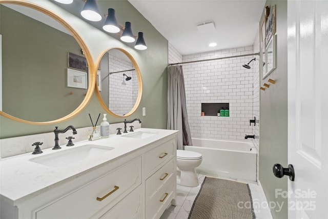 full bath featuring double vanity, shower / bath combo with shower curtain, toilet, and a sink