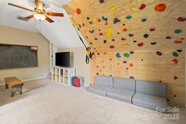 unfurnished living room with visible vents, ceiling fan, baseboards, carpet floors, and vaulted ceiling