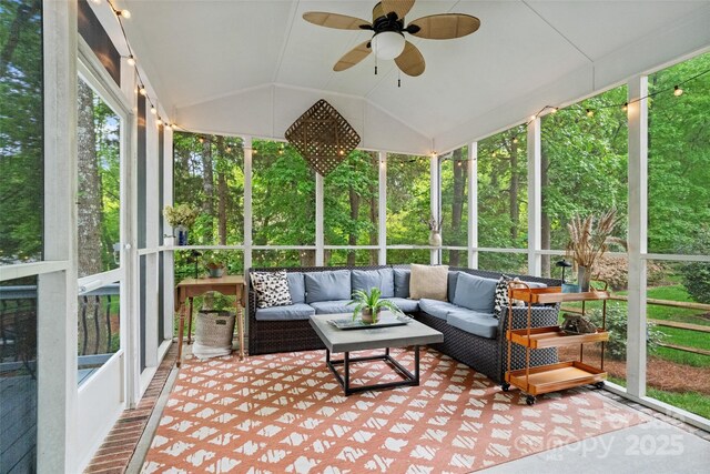 sunroom featuring ceiling fan and an outdoor living space