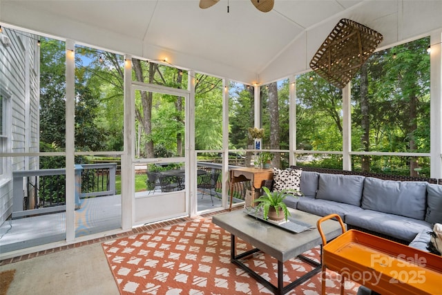 sunroom featuring an outdoor living space and ceiling fan