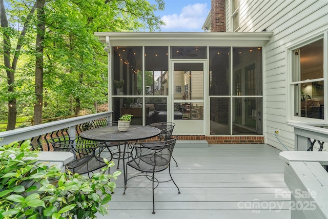 wooden deck featuring a sunroom