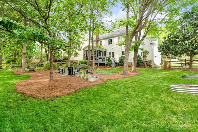 view of yard with fence and a sunroom