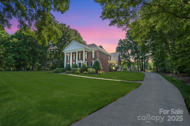 1721 White Pond Ln, Waxhaw, NC 28173 - neoclassical home featuring a front yard and brick siding