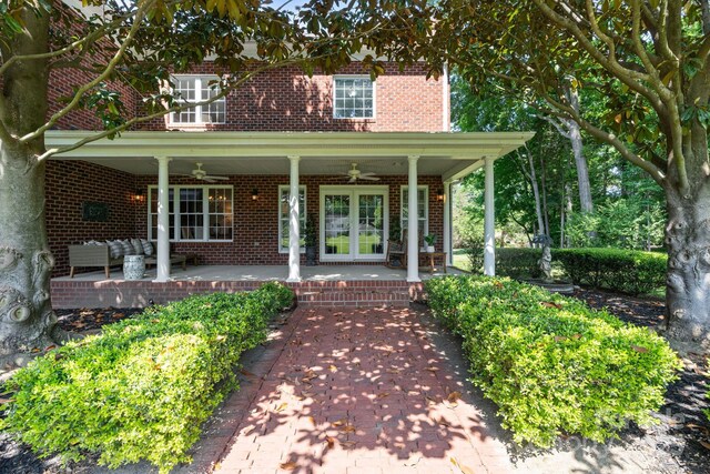1721 White Pond Ln, Waxhaw, NC 28173 - view of exterior entry with a ceiling fan, brick siding, french doors, and an outdoor living space