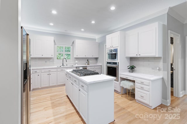 1721 White Pond Ln, Waxhaw, NC 28173 - kitchen with appliances with stainless steel finishes, ornamental molding, a kitchen island, a sink, and decorative backsplash