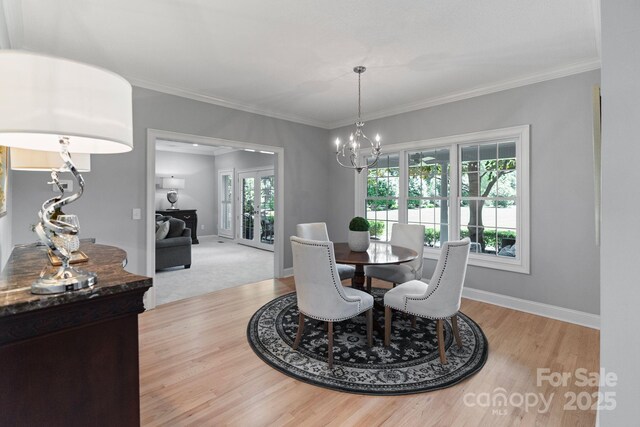 1721 White Pond Ln, Waxhaw, NC 28173 - dining room featuring light wood finished floors, a chandelier, baseboards, and crown molding