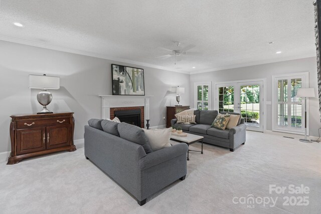 1721 White Pond Ln, Waxhaw, NC 28173 - living room featuring light colored carpet, a ceiling fan, a brick fireplace, a textured ceiling, and crown molding