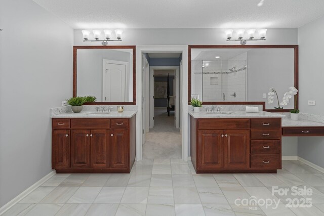 1721 White Pond Ln, Waxhaw, NC 28173 - full bathroom featuring a shower stall, two vanities, a textured ceiling, and baseboards