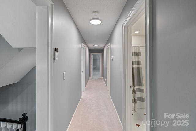 1721 White Pond Ln, Waxhaw, NC 28173 - corridor with baseboards, light carpet, and a textured ceiling