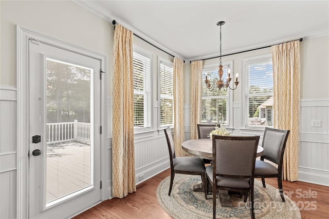 7923 Mountain Shore Dr, Sherrills Ford, NC 28673 - dining room featuring a decorative wall, a chandelier, wood finished floors, wainscoting, and ornamental molding