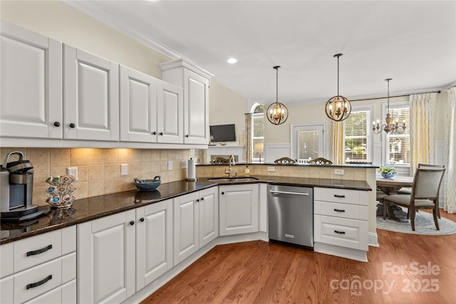 7923 Mountain Shore Dr, Sherrills Ford, NC 28673 - kitchen with stainless steel dishwasher, a sink, a chandelier, wood finished floors, and ornamental molding