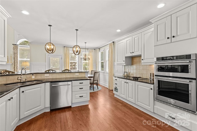 7923 Mountain Shore Dr, Sherrills Ford, NC 28673 - kitchen with appliances with stainless steel finishes, a sink, a chandelier, dark countertops, and white cabinetry