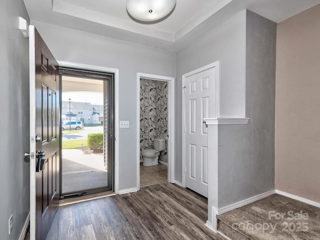 entryway with wood finished floors and baseboards