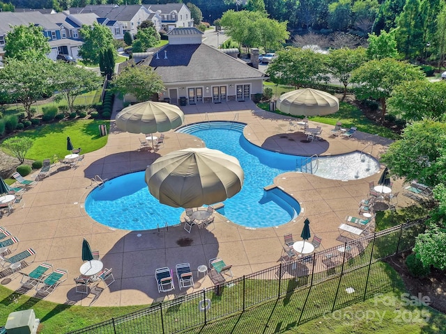 pool featuring fence and a patio area