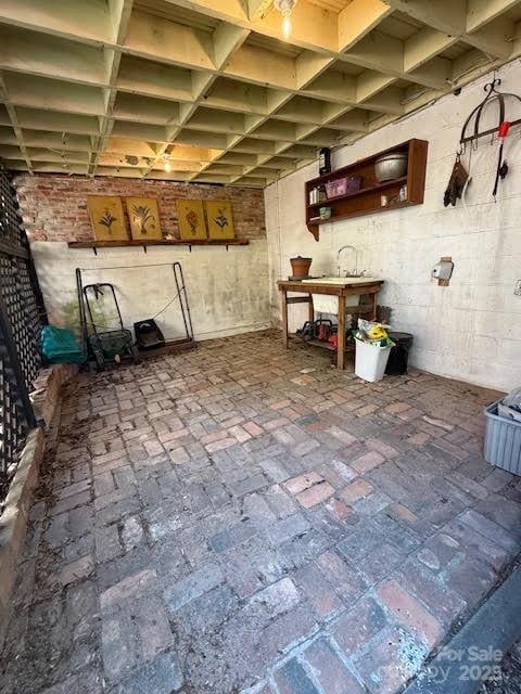below grade area featuring brick flooring