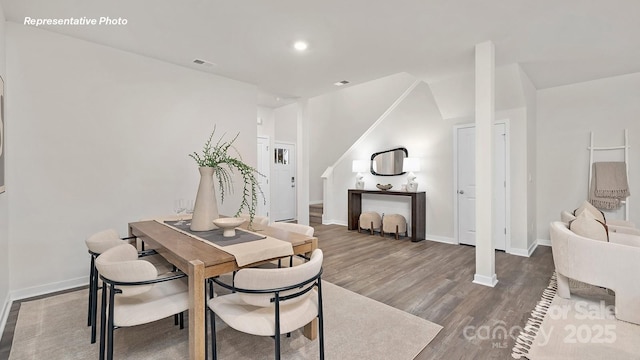 dining space featuring visible vents, baseboards, recessed lighting, vaulted ceiling, and wood finished floors