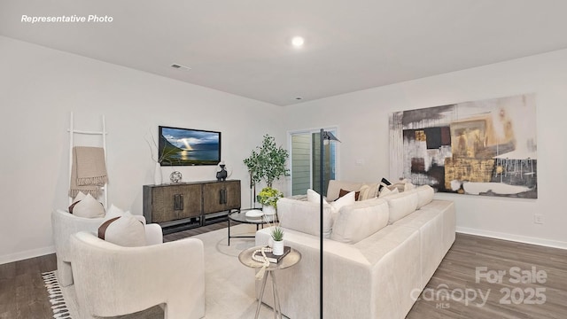 living room with recessed lighting, visible vents, wood finished floors, and baseboards