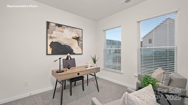 carpeted home office with visible vents and baseboards