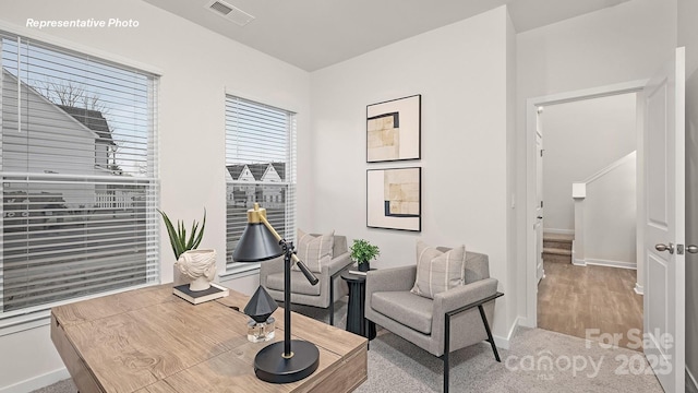sitting room with visible vents, carpet flooring, and baseboards